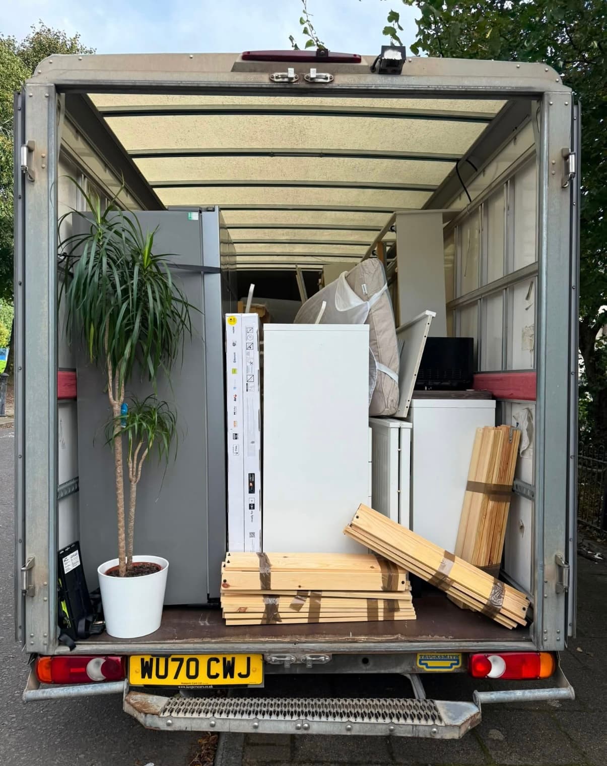Packed boxes and protected furniture loaded into a Luton van for a house move